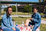 Two young people outside smiling